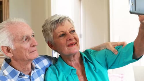 Smiling Senior Couple Takes Selfie Together at Home