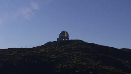 A modern astronomical observatory in a vast meadow valley during a night. 4KHD