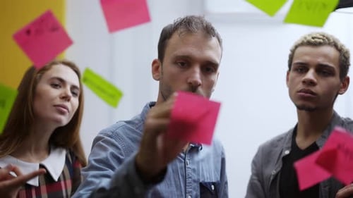 Diverse Group of Finance Office Worker Having Corporate Training and Using Glass Wall with Stickers