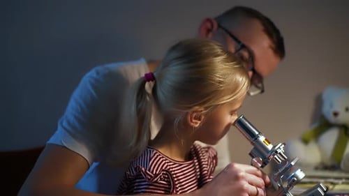 Father and Daughter Explore the World with Microscope