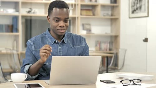 Young Man in Video Conference at Desk
