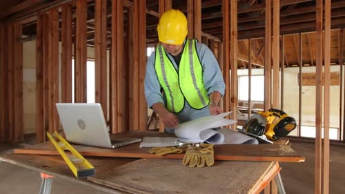Construction worker uses laptop computer