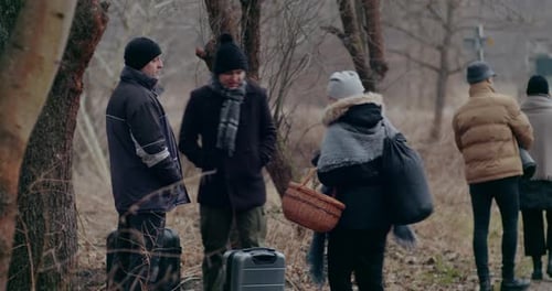 Group of People with Luggage in a Forest