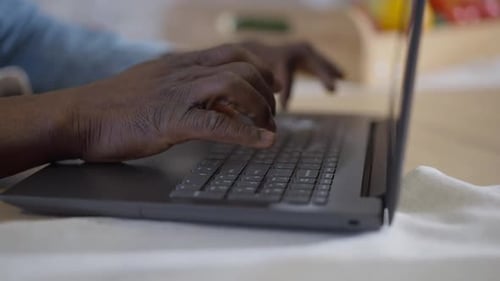 Hands Typing on a Laptop Keyboard Close-Up