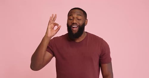 Man Gives OK Sign with Positive Expression