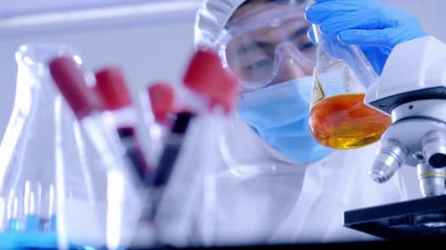 Scientist Mixing Liquids in Laboratory Setting