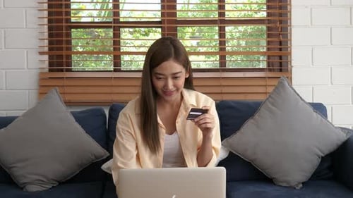 Woman Shops Online, Using Credit Card at Home