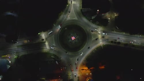 Aerial View Timelapse of Roundabout Road with Circular Cars at Night in Small European City