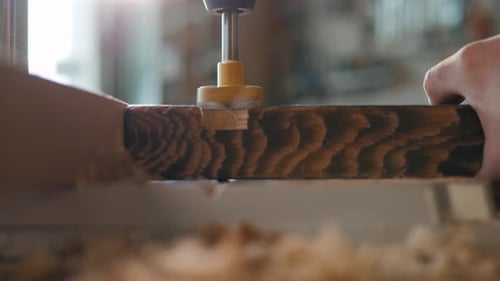 Drill bores into piece of wood