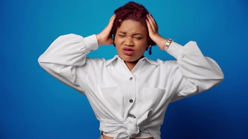 Concerned Young Adult Female With Hands on Head