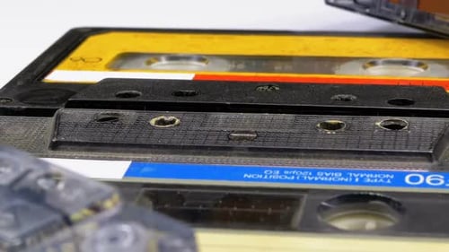 Four Audio Cassettes Rotate on White Background