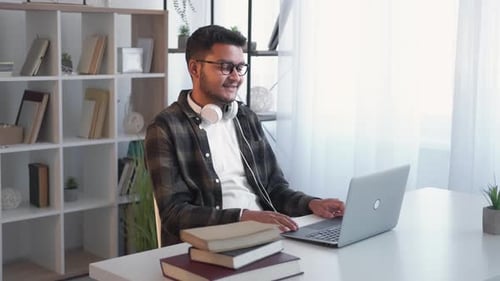Man Working on Laptop in Bright Room