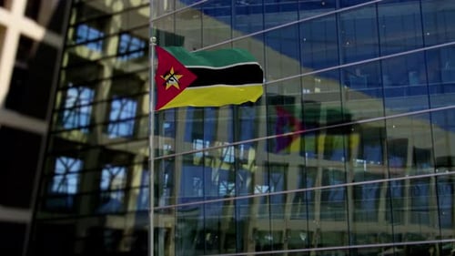 Realistic Mozambique Flag Waving Against Modern Corporate Building