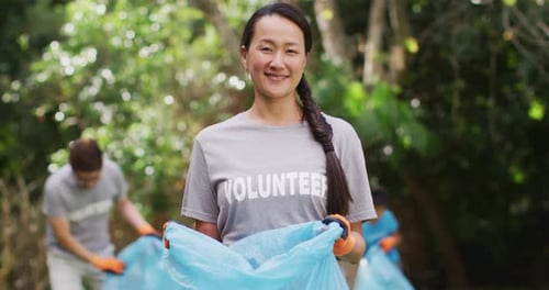 Enthusiastic Volunteers Cleaning up Park Together