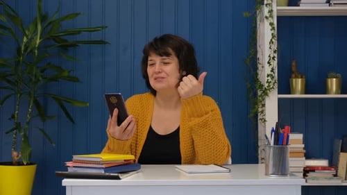 Woman Engages in Video Call at Her Desk