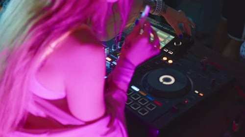 Blonde Female DJ Mixing Music at Nightclub