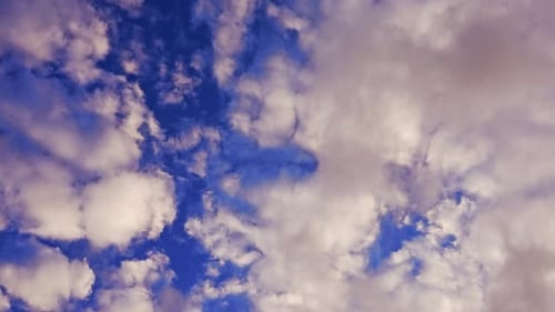 Clouds Drifting Slowly Across Blue Sky