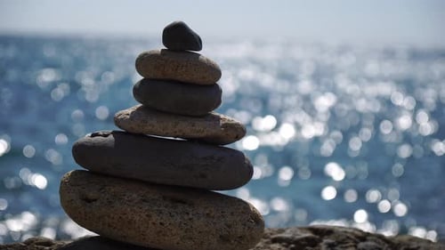 Balanced Pebble Pyramid on the Beach on a Sunny Day