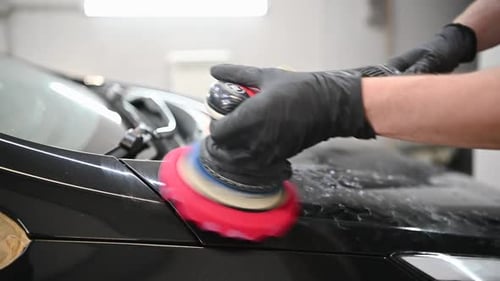 Car Detailing Hands with Orbital Polisher in Auto Repair Shop in Slow Motion