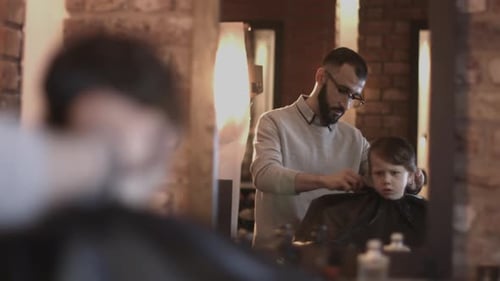 Barber Giving Young Boy a Haircut