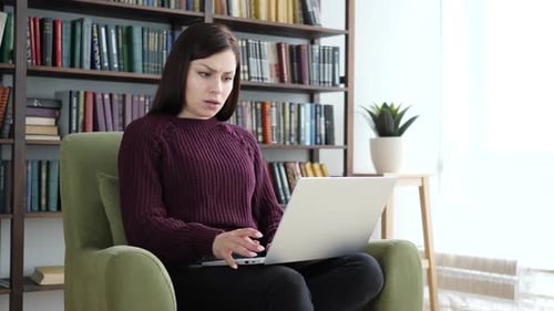 Angry Woman Reacting to Problems of Work Sitting on Sofa