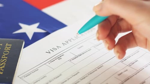 Visa Application Being Filled Out on American Flag