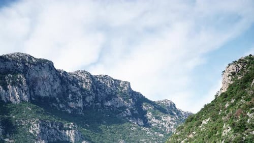 Majestic Mountains and Partly Cloudy Sky
