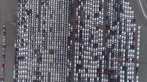 Motion Over Rows of Finished Cars at Open Warehouse Lot