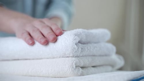Folding Soft White Towels in an Organised Manner