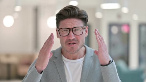 Man Reacts in Disbelief in Office Setting