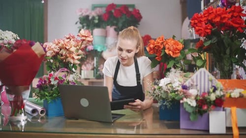 Woman Working in Flower Shop Using Technology