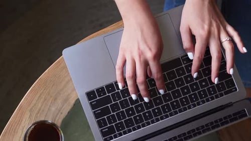 Female Hands Are Typing on the Keyboard