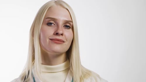 Young Woman Doctor Shows a Green Pill