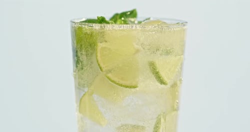 Refreshing Mojito Cocktail Being Poured into Glass