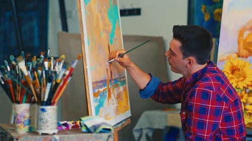 Young Man Painting Abstract Art in Studio