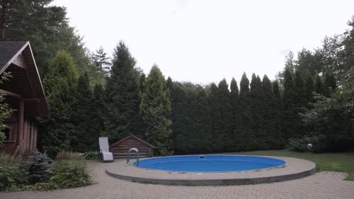 Relaxation Yard of Wooden House with Swimming Pool and a Sun Lounger Next to It