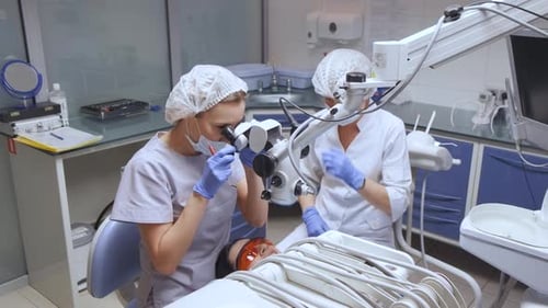 Dentists Using Microscope for Dental Examination