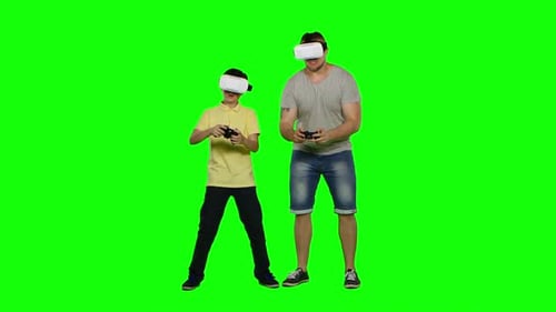 Father and Son Playing in Virtual Reality Glasses. Green Screen