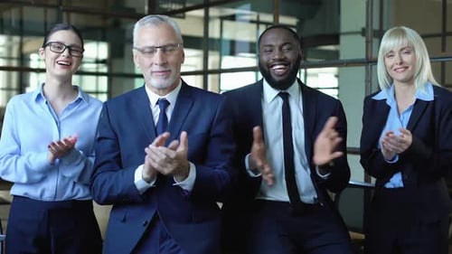 Diverse Business Team Applauds in Modern Office