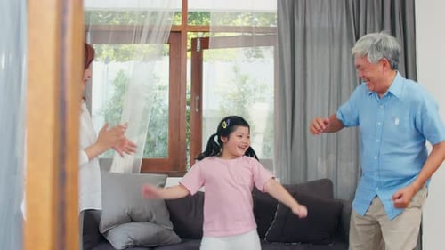Happy Family Dancing Together in Living Room