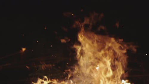 Burning Flames with Rising Embers on Black Background