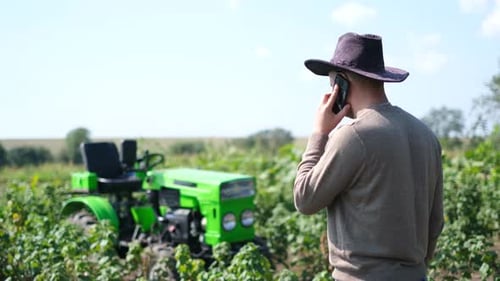 Farmer Talking on Cell Phone in Field