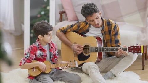 Young Adult and Child Play Instruments Together