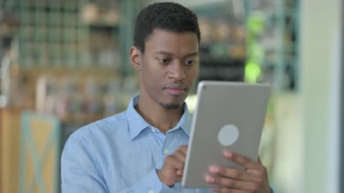 Young Adult Using Tablet Device in Workplace