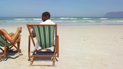 Couple toasting glasses of cocktails at beach 4k
