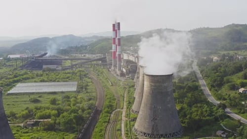 Aerial View of the Pipes of a Coal Power Plant and Cooling Tower