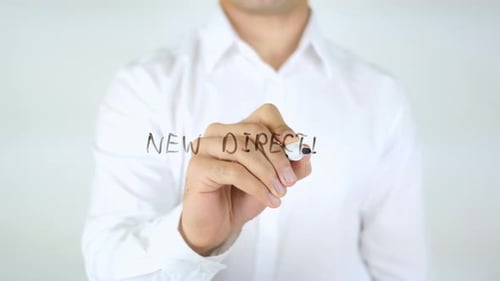 Man Writes "New Direction" on Clear Surface