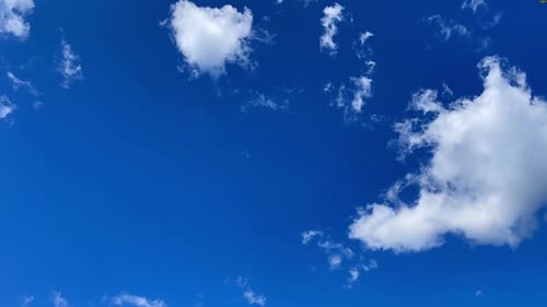 Clouds Slowly Drifting Across the Bright Blue Sky