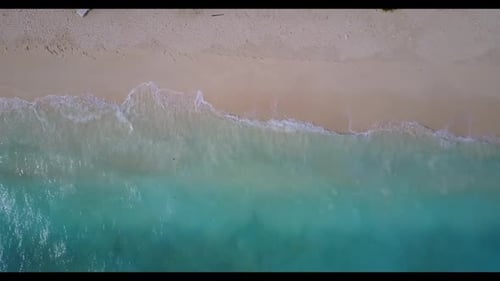 Aerial drone shot landscape of paradise bay beach break by blue green lagoon with white sandy backgr