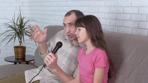 Father and Daughter Singing Together at Home